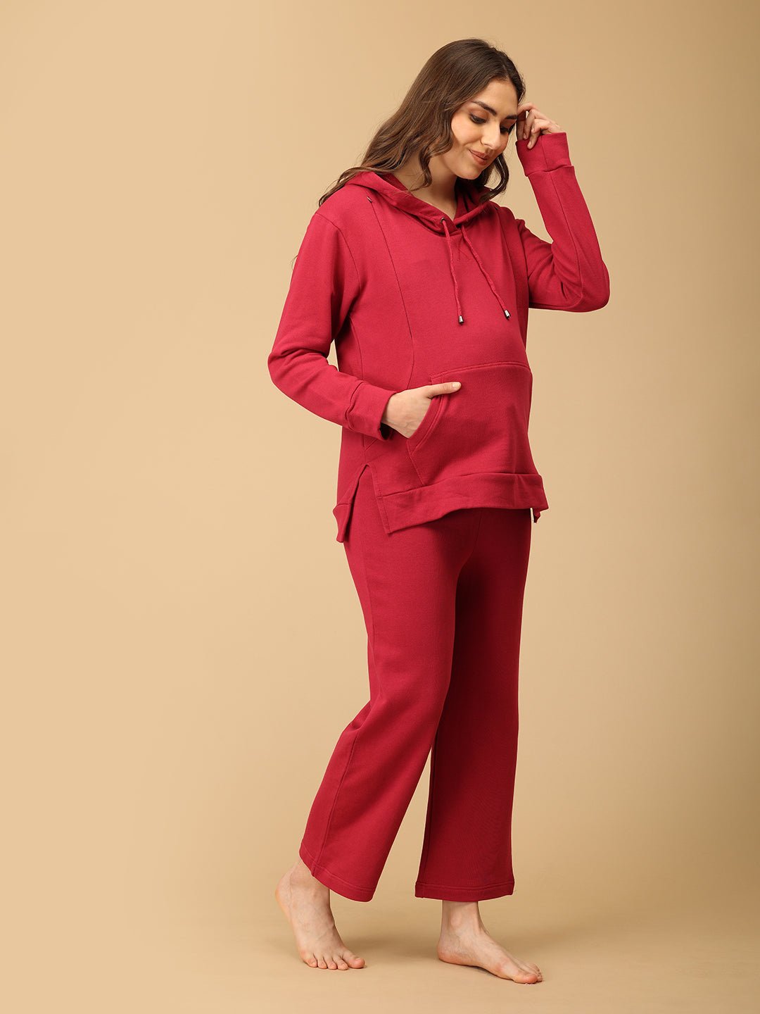 Smiling woman wearing The Mom Store magenta maternity hoodie set with soft cotton fabric comfort