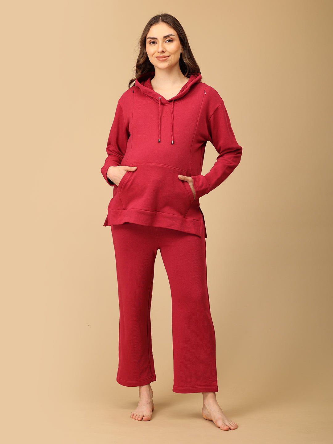 Smiling woman wearing The Mom Store magenta maternity hoodie set with soft cotton fabric comfort.
