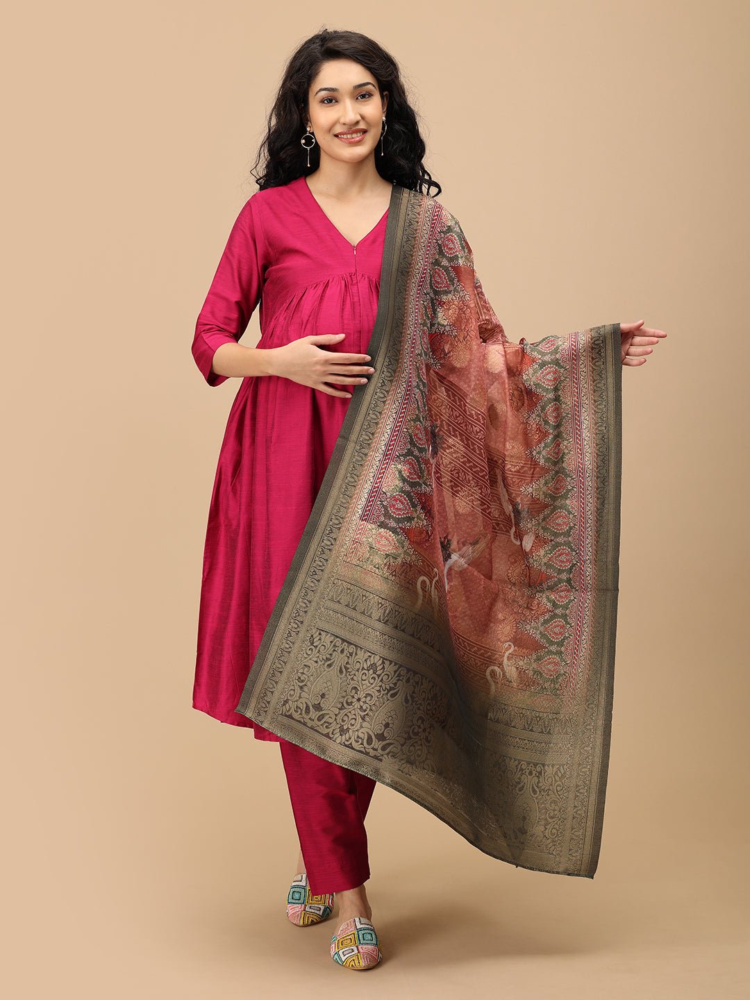 Woman draped in ornate dupatta wearing The Mom Store magenta maternity silk kurta set front view.