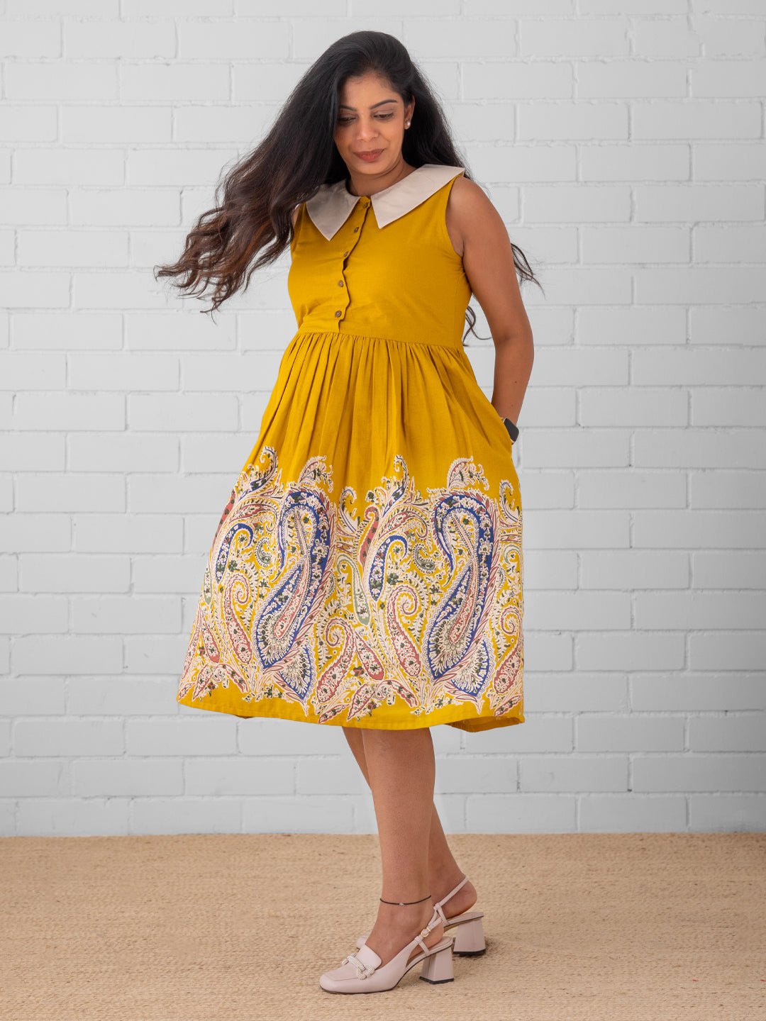 Smiling pregnant woman in bright yellow printed maternity and nursing dress – The Mom Store.