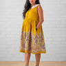 Pregnant woman wearing yellow Marigold Mirage maternity dress with paisley print – The Mom Store.
