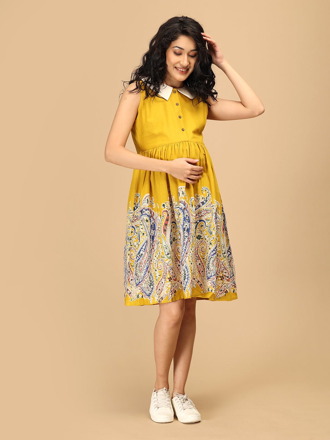 Front pose of The Mom Store marigold maternity and nursing dress with contrast collar and paisley hem.