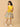 Pregnant woman in The Mom Store marigold nursing dress posing with bump-friendly fit.