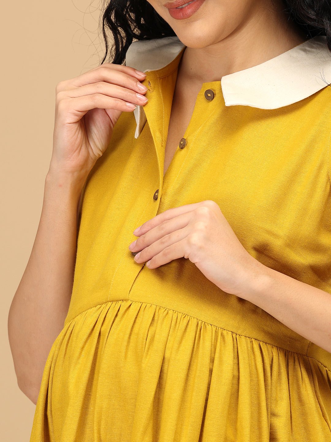 Close-up of The Mom Store marigold maternity and nursing dress with button-down feeding access.