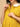 Close-up of The Mom Store marigold maternity and nursing dress with button-down feeding access.