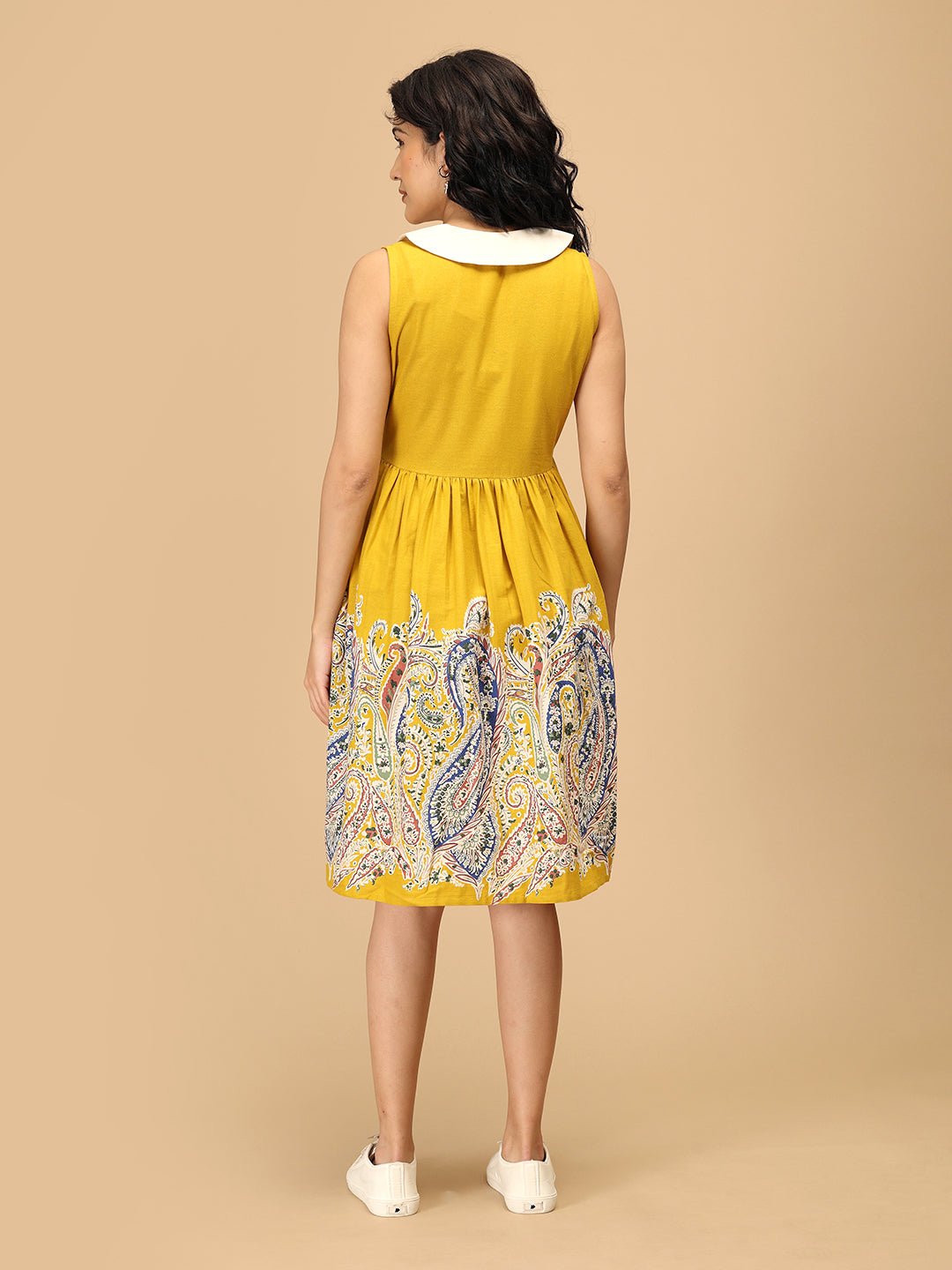 Back view of The Mom Store marigold maternity dress with paisley printed flare skirt.