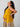 Pregnant woman in yellow maternity dress relaxing and holding baby bump ‚Äì The Mom Store