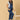 Relaxed pose of pregnant woman in The Mom Store blue Denim Maternity Dungaree with Side Buttons and sunglasses