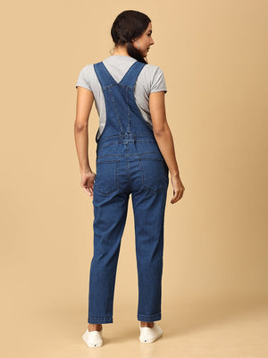 back view of pregnant woman in The Mom Store blue Denim Maternity Dungaree with Side Buttons 
