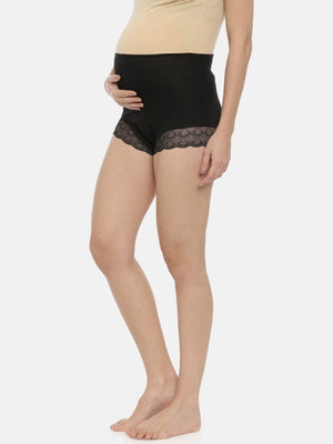 Sidepose by Model wearing black coloured Mama Over Belly Support Panties from the Mom Store