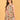 Mid-length front view of Abstract Flora Maternity and Nursing Dress styled with neutral heels and clutch.