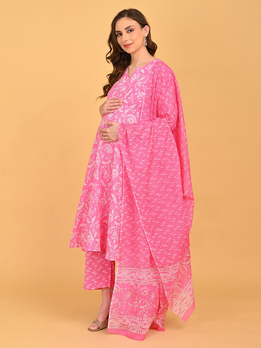 Angled front pose of pink maternity kurta set with flowing dupatta and bump-friendly silhouette.