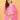 Model styling pink maternity kurta set with dupatta and beige handbag for festive wear.