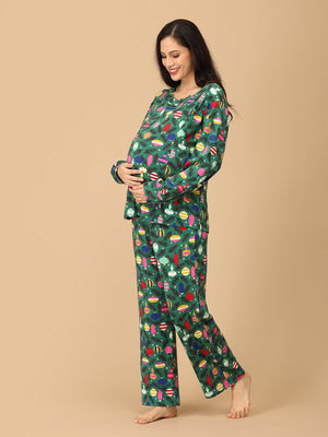 Playful side pose by Pregnant model wearing Merry Snuggle Squad Maternity Pajama Set from the mom store touching her belly