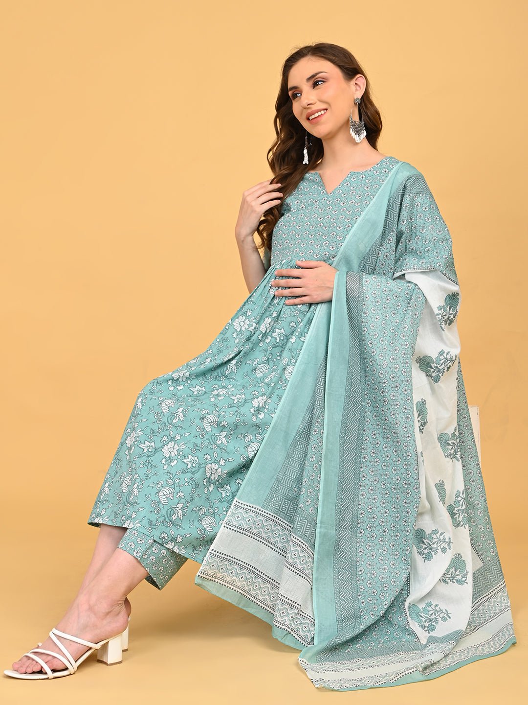 Model seated wearing MintSaheli Maternity and Nursing Kurta Set With Dupatta in mint green floral print with matching dupatta.