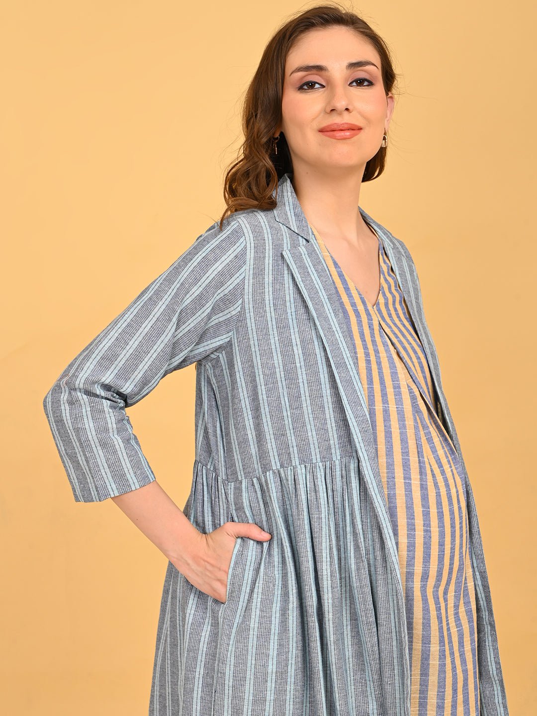 Modern Loom Maternity and Nursing Shacket Dress side view with model hand in pocket highlighting comfortable fit and striped texture.