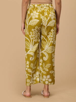 Back view of mustard printed maternity pants with comfortable elastic waist.