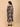 Back view of The Mom Store Muted Muse maternity dress with patch-print floral pattern and ruffle hem.