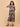 Pregnant woman in The Mom Store Muted Muse maternity and nursing dress with geometric floral print.