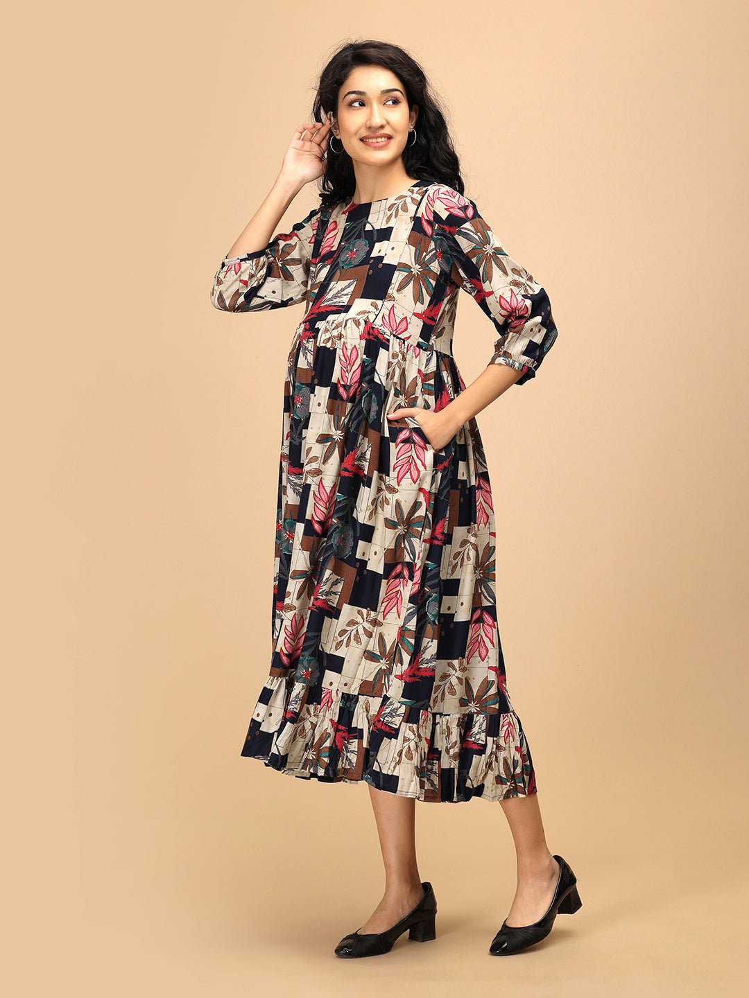 Side view of The Mom Store Muted Muse maternity and nursing dress with relaxed fit and ruffle hem.