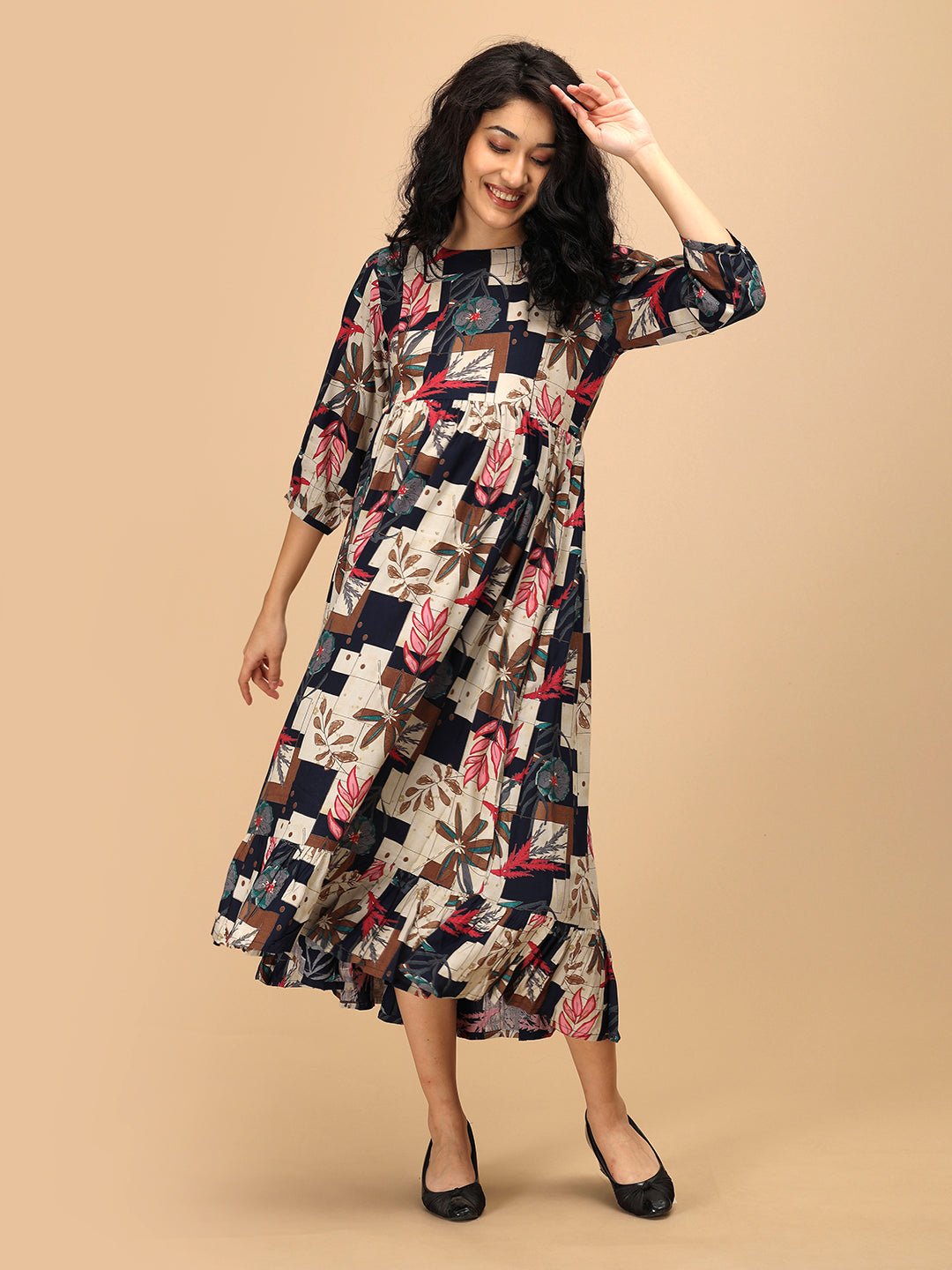 Side angle of The Mom Store Muted Muse maternity dress with flared silhouette and bold prints.