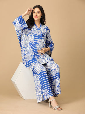 Model sitting on a white hexagonal block posing sideways wearing mykonos magic maternity and nursing Co-ord set from the mom store