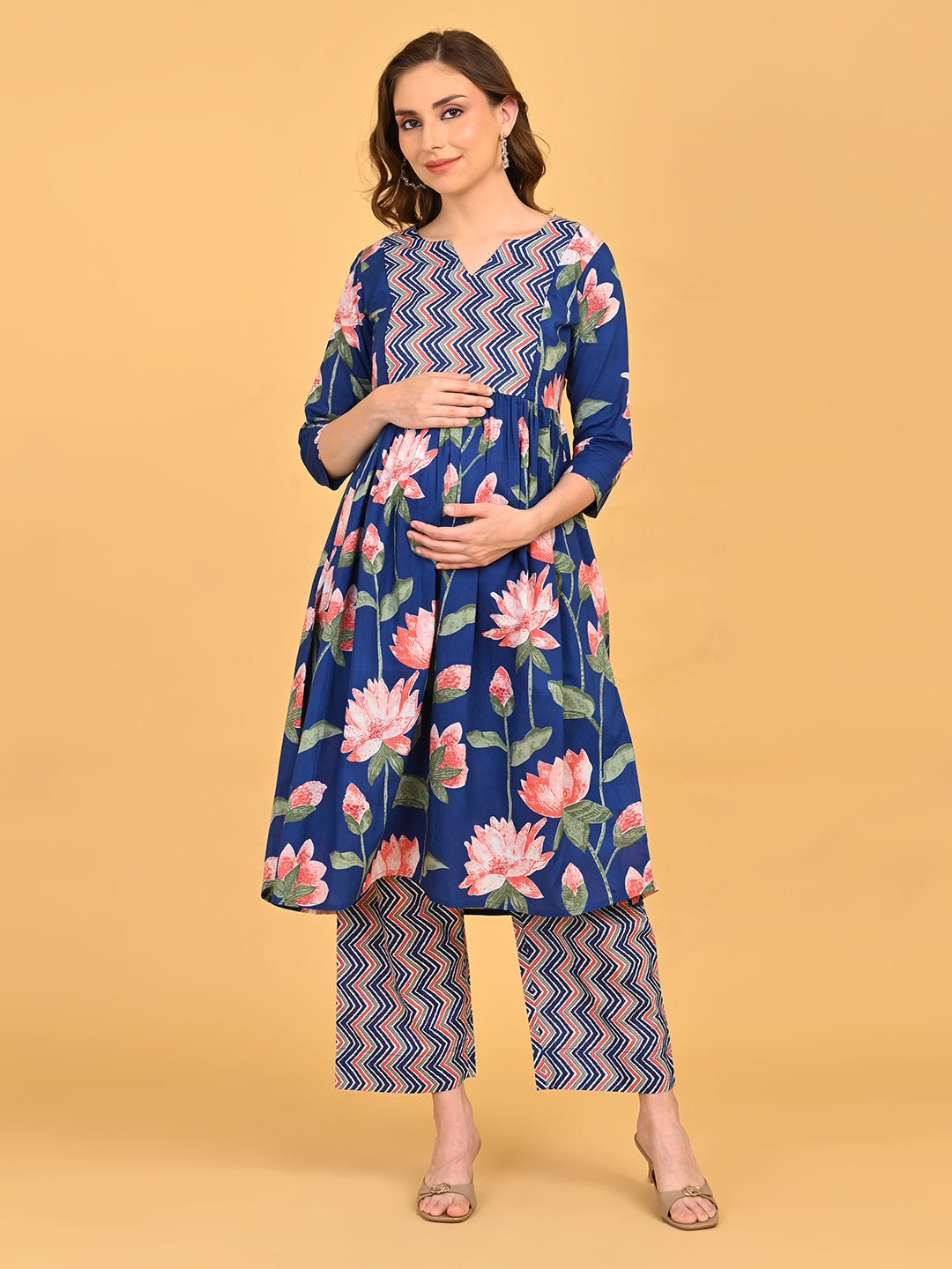 Model posing in NeelVaani Maternity Kurta Set displaying floral print, three-quarter sleeves and matching printed pants.