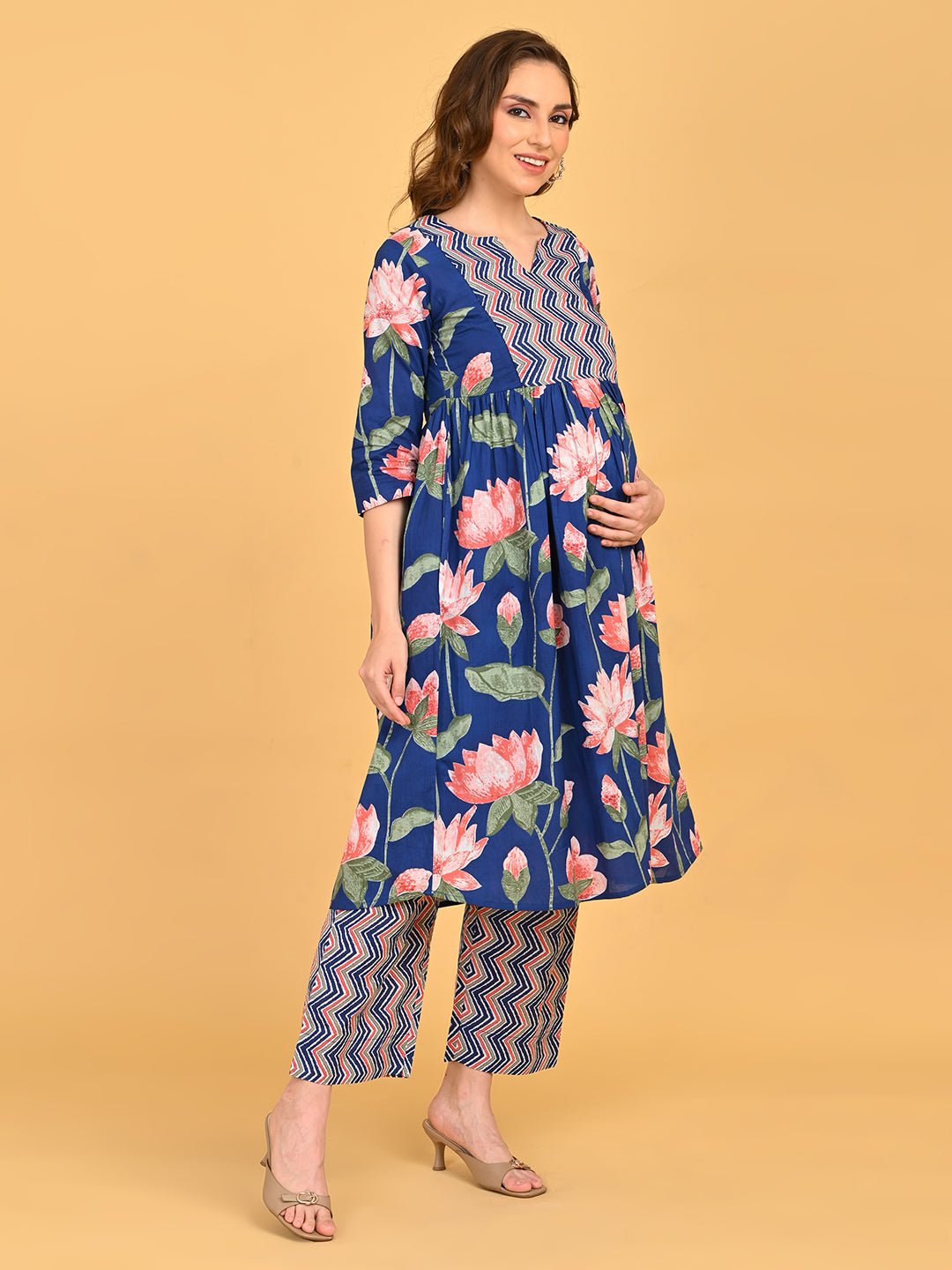 Model posing in NeelVaani Maternity Kurta Set displaying floral print, three-quarter sleeves and matching printed pants.