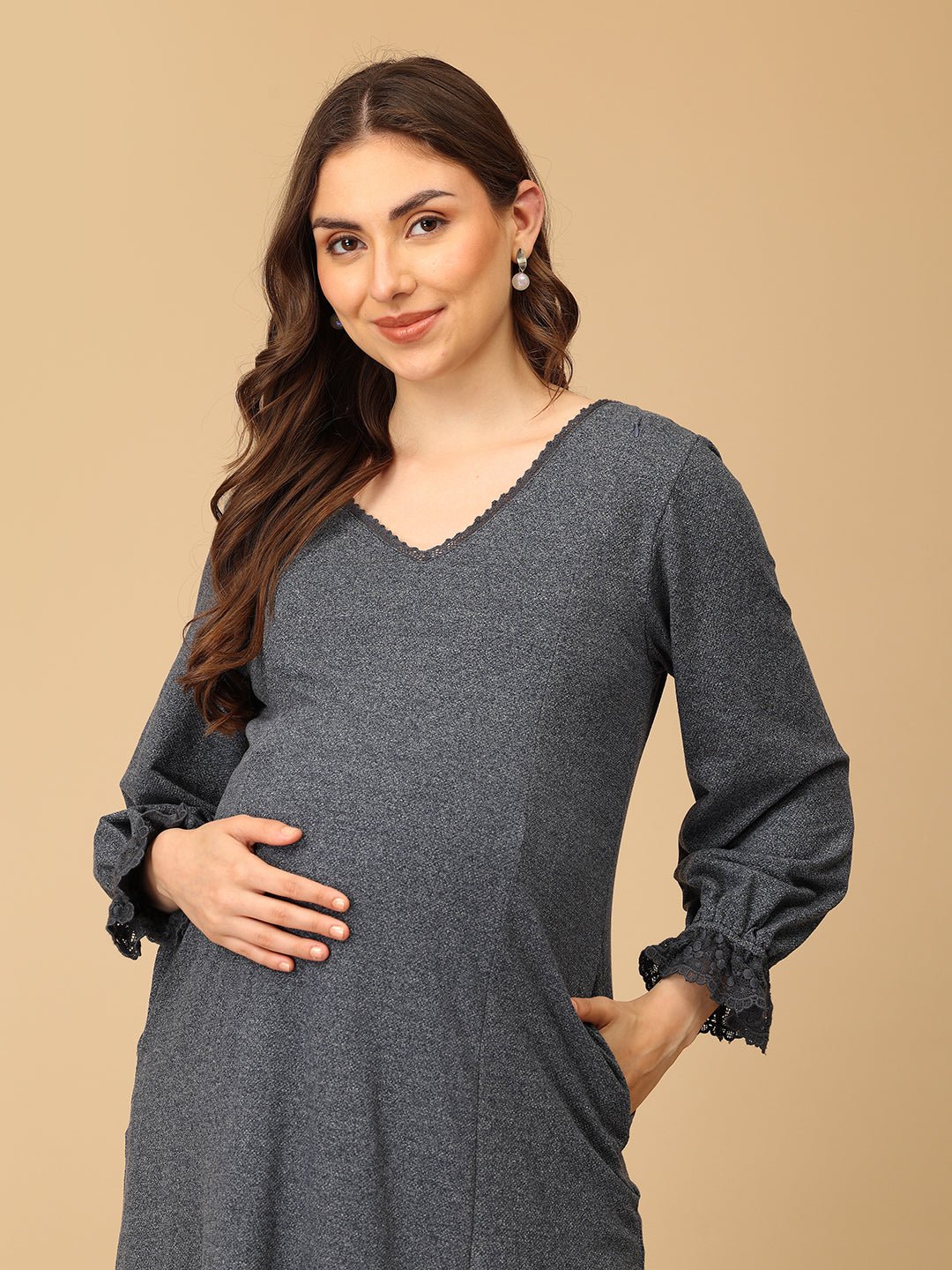 The Mom Store maternity sweater dress with delicate lace neckline and cuff detailing for a chic winter look.