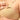 Model showing opening flap of beige non-padded nursing bra from the mom store
