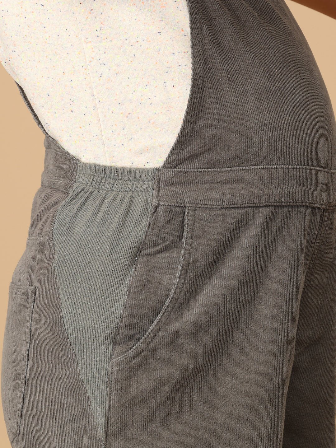 Elastic expandable side panel detail on The Mom Store olive corduroy maternity dungaree.