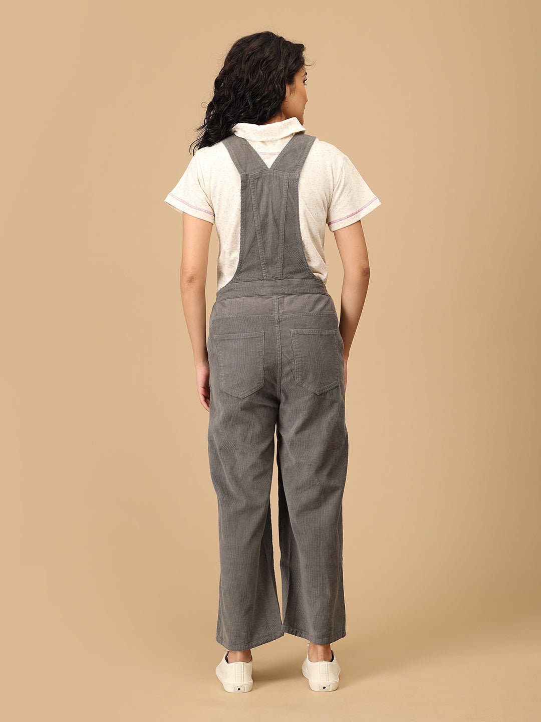 Back view of The Mom Store olive corduroy maternity dungaree with cross-back straps and pockets.