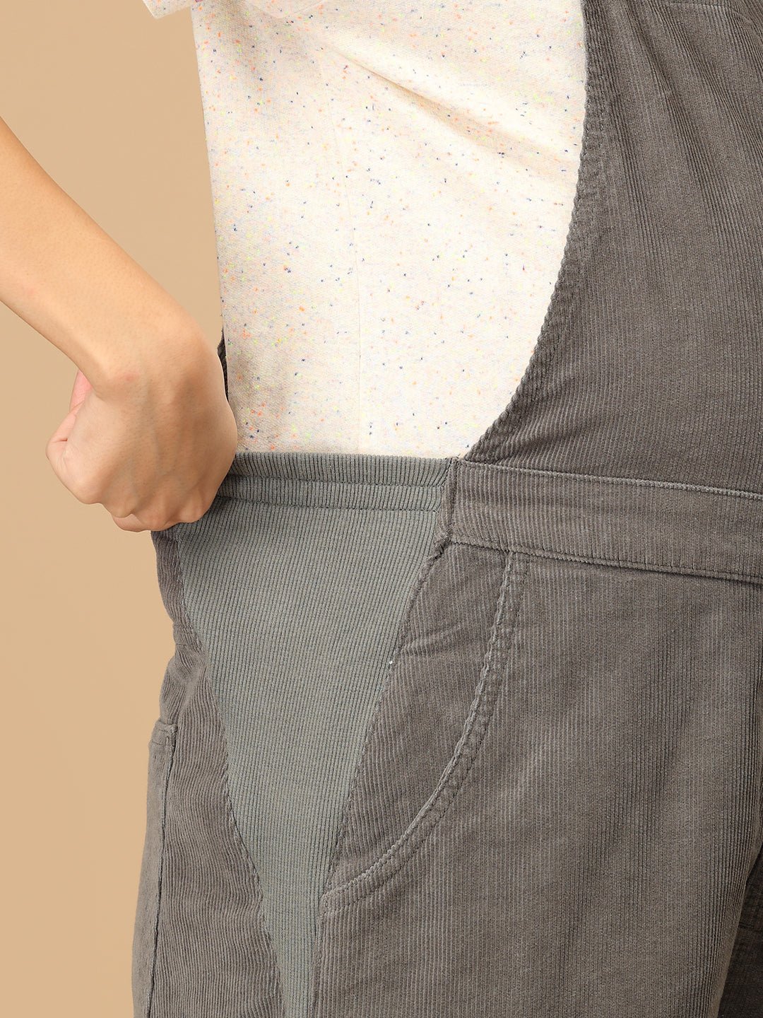 Close-up of stretch side panel on The Mom Store olive corduroy maternity dungaree for belly comfort.