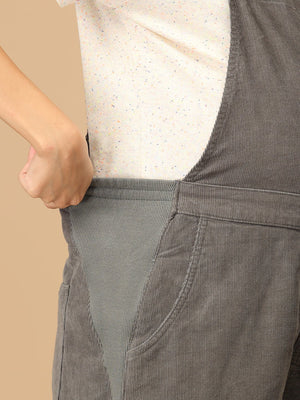 Close-up of stretch side panel on The Mom Store olive corduroy maternity dungaree for belly comfort.