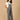 Pregnant woman wearing The Mom Store olive corduroy maternity dungaree with relaxed front stance.