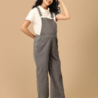 Pregnant woman wearing The Mom Store olive corduroy maternity dungaree with relaxed front stance.