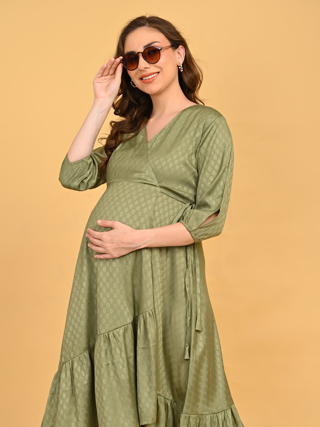 Olivious Maternity Wrap Dress front view styled with sunglasses, highlighting V-neckline and wrap detail.