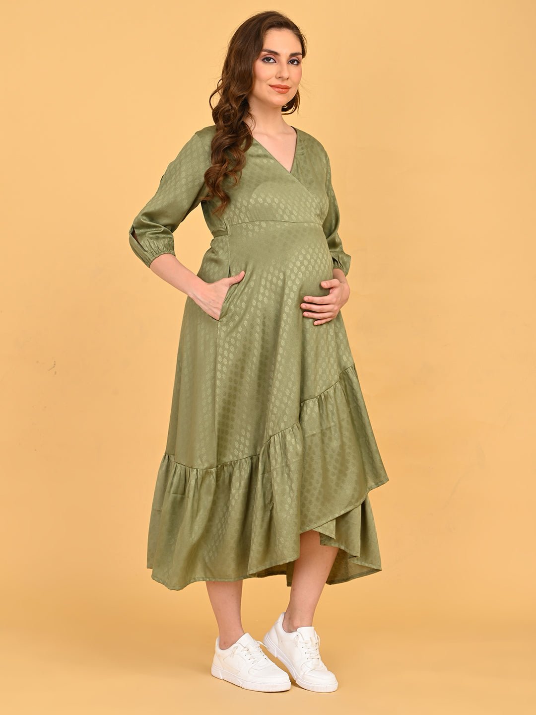 Olivious Maternity Wrap Dress three-quarter front pose with hand in pocket, showing comfortable fit and textured finish.
