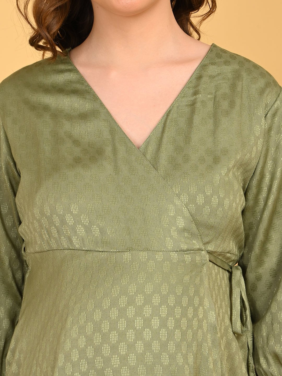 Olivious Maternity Wrap Dress close-up of V-neck wrap bodice with subtle textured fabric and empire waist seam.