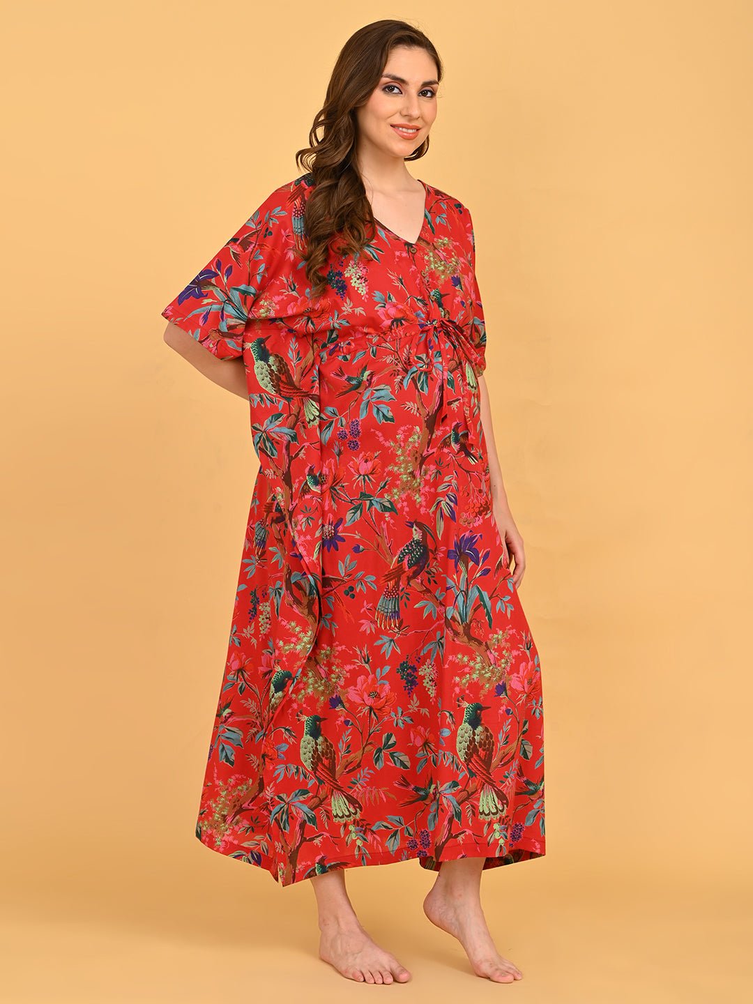 Painted Breeze Maternity and Nursing Kaftan Nighty three-quarter front pose with model gently holding baby bump, highlighting adjustable empire waist tie.