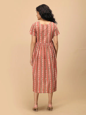 Peach Mirage Maternity and Nursing Dress ‚Äì back view showing gathered waist and flowy skirt.
