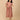 Peach Mirage Maternity and Nursing Dress ‚Äì model in midi dress with side tie, smiling front view.