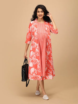 Peach printed maternity and nursing dress styled with a matching shacket and black tote bag for a casual outing look.