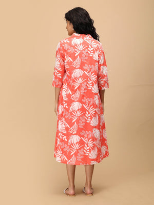 Back view of peach printed maternity shacket dress showing relaxed fit and three-quarter sleeves.