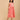 Angled view of peach printed maternity dress showing flowy silhouette and lightweight cotton fabric.