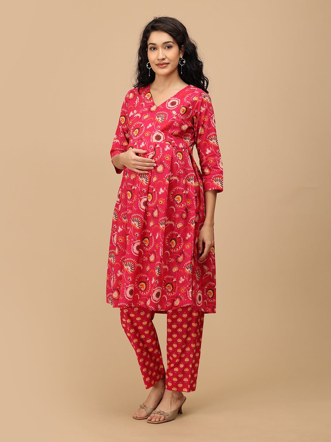 Side angle of the printed pink maternity pants showing the relaxed straight silhouette and comfortable fit.