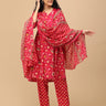 Angled front view of the printed pink maternity kurta paired with matching pants, model lightly touching her hair.