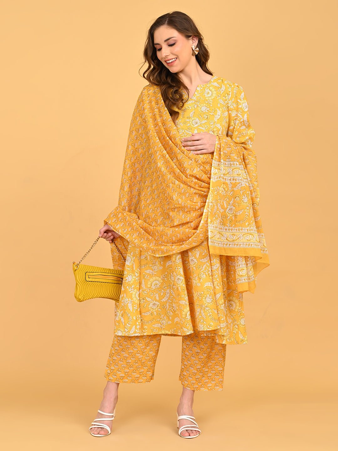 Yellow maternity kurta set styled with matching dupatta and textured yellow clutch for festive wear.