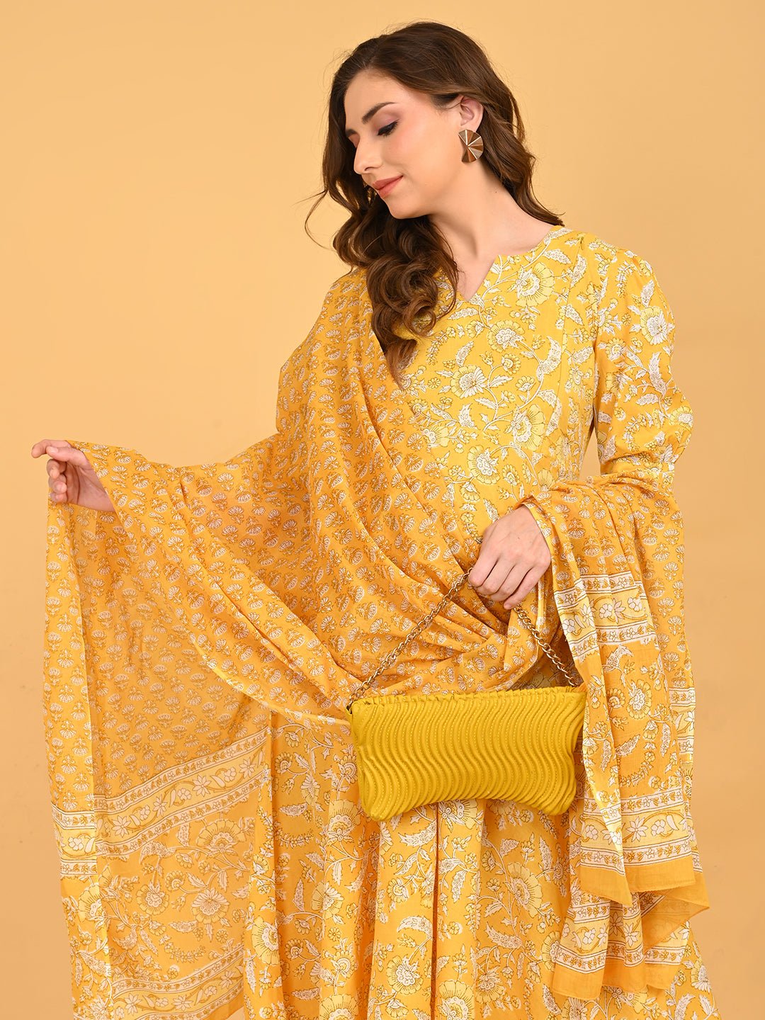 Yellow maternity kurta set styled with matching dupatta and textured yellow clutch for festive wear.