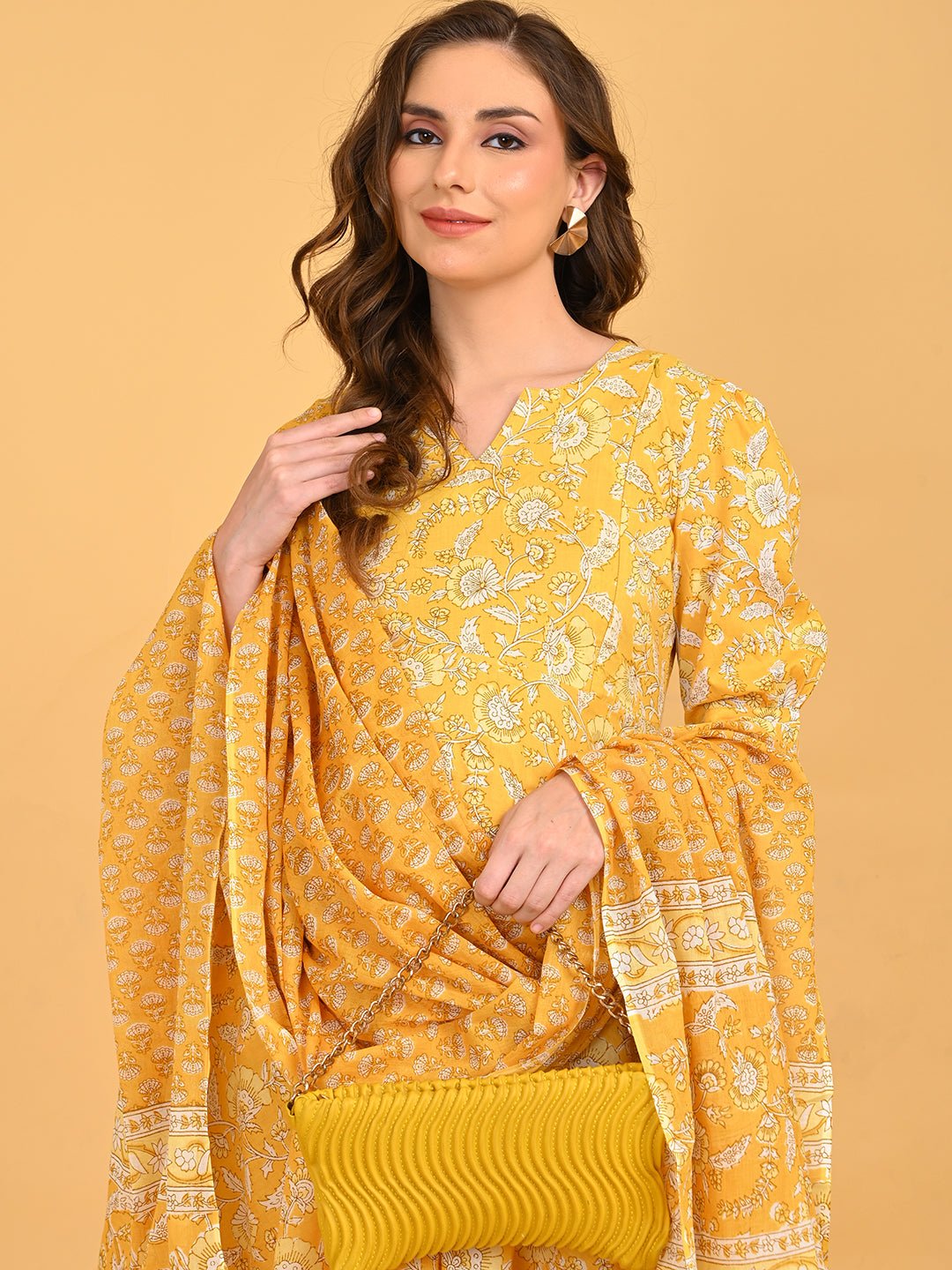 Yellow maternity kurta set styled with matching dupatta and textured yellow clutch for festive wear.